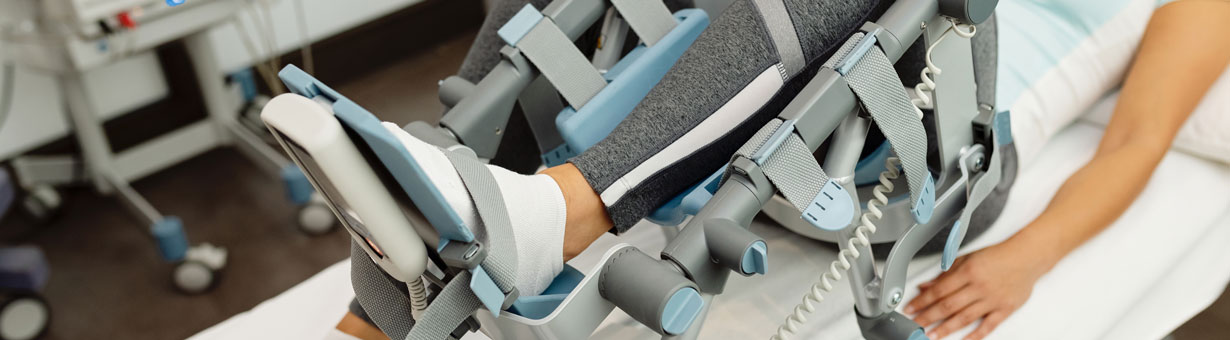 Close-up of woman during physical rehabilitation with arthromot device. Close-up of woman during physical rehabilitation with arthromot device.